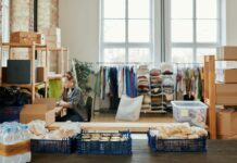 Supply Chain Management for a Flawless D2C Brand Warehouse with packaged food and clothing storage, worker organizing stock indoors.